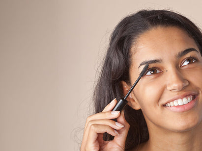woman applying mascara