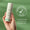 En hand håller en flaska Vita Min Fix 24-Hour Cream mot en grön bakgrund med ett sigill som visar att produkten är dermatologiskt testad.
