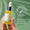 En hand håller en flaska med pipett av Green People Anti Ageing Facial Oil mot en grön bakgrund med ett sigill för dermatologiskt testad.